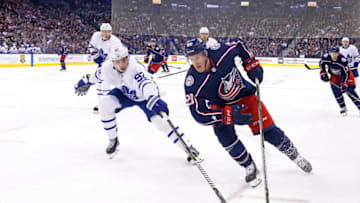 COLUMBUS, OH - DECEMBER 28: Riley Nash #20 of the Columbus Blue Jackets attempts to skate the puck around Igor Ozhiganov #92 of the Toronto Maple Leafs during the second period on December 28, 2018 at Nationwide Arena in Columbus, Ohio. (Photo by Kirk Irwin/Getty Images)