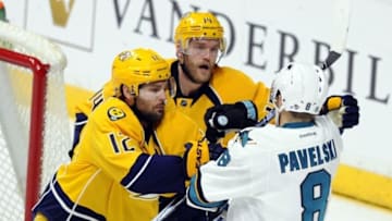 Apr 2, 2016; Nashville, TN, USA; Nashville Predators center Mike Fisher (12) and Nashville Predators defenseman Mattias Ekholm (14) hit San Jose Sharks center Joe Pavelski (8) after the whistle during the second period at Bridgestone Arena. Mandatory Credit: Christopher Hanewinckel-USA TODAY Sports