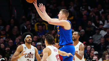Jan 6, 2023; Denver, Colorado, USA; Denver Nuggets center Nikola Jokic (15) passes for an assist over Cleveland Cavaliers center Jarrett Allen (31) and guard Raul Neto (19) and guard Raul Neto (19) in the second half at Ball Arena. Mandatory Credit: Ron Chenoy-USA TODAY Sports