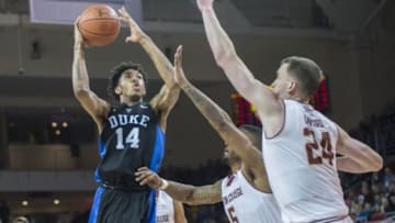 Jan 2, 2016; Chestnut Hill, MA, USA; Duke Blue Devils guard Brandon Ingram (14) shoots the ball as Boston College Eagles forward Garland Owens (5) and center Dennis Clifford (24) defend during the second half of the game at Silvio O. Conte Forum. Duke won 81-64. Mandatory Credit: Gregory J. Fisher-USA TODAY Sports