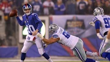 Dec 11, 2016; East Rutherford, NJ, USA; New York Giants quarterback Eli Manning (10) is pressured by Dallas Cowboys defensive tackle Tyrone Crawford (98) as he looks to pass during the first quarter at MetLife Stadium. Mandatory Credit: Brad Penner-USA TODAY Sports