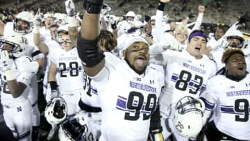 IOWA CITY, IOWA- NOVEMBER 10: Defensive lineman Jordan Thompson #99 of the Northwestern Wildcats joins teammates in singing their fight song after they defeated the Iowa Hawkeyes, on November 10, 2018 at Kinnick Stadium, in Iowa City, Iowa. (Photo by Matthew Holst/Getty Images)