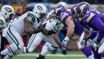 Dec 7, 2014; Minneapolis, MN, USA; Minnesota Vikings center John Sullivan (65) blocks New York Jets defensive tackle Damon Harrison (94) in the third quarter at TCF Bank Stadium. The Vikings win 30-24. Mandatory Credit: Bruce Kluckhohn-USA TODAY Sports