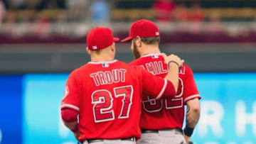Sep 4, 2014; Minneapolis, MN, USA; Los Angeles Angels center fielder Mike Trout (27) and left fielder Josh Hamilton (32) talk on the way to the outfield in the second inning against the Minnesota Twins at Target Field. Mandatory Credit: Brad Rempel-USA TODAY Sports