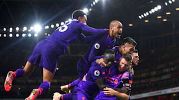LONDON, ENGLAND - NOVEMBER 03: James Milner of Liverpool celebrates with Sadio Mane, Andy Robertson, Roberto Firmino and Fabinho of Liverpool after he scores his sides first goal during the Premier League match between Arsenal FC and Liverpool FC at Emirates Stadium on November 3, 2018 in London, United Kingdom. (Photo by Michael Regan/Getty Images)