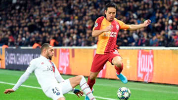 Paris Saint-Germain's French defender Layvin Kurzawa (L) is tackled by Galatasaray's Japanese defender Yuto Nagatomo during the UEFA Champions League Group A football match between Paris Saint-Germain (PSG) and Galatasaray at the Parc des Princes stadium in Paris on December 11, 2019. (Photo by Bertrand GUAY / AFP) (Photo by BERTRAND GUAY/AFP via Getty Images)