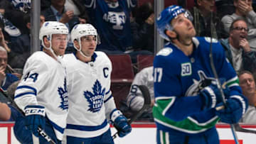 John Tavares #91 of the Toronto Maple Leafs celebrates with teammate Morgan Rielly #44 after scoring a goal as Josh Leivo #17 of the Vancouver Canucks watches the replay on the big screen during NHL action at Rogers Arena. (Photo by Rich Lam/Getty Images)