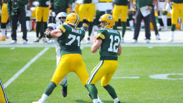 Sep 20, 2020; Green Bay, Wisconsin, USA; Green Bay Packers quarterback Aaron Rodgers (12) and Green Bay Packers offensive tackle Rick Wagner (71) against the Detroit Lions at Lambeau Field. Mandatory Credit: Michael McLoone-USA TODAY Sports