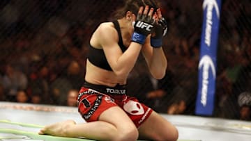 Mar 14, 2015; Dallas, TX, USA; Joanna Jedrzejczyk (blue) celebrates defeating Carla Esparza (red) in the women
