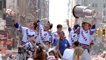 UNITED STATES - JUNE 17: Adam Graves (far left) and Captain Mark Messier (sunglasses) with Ranger teammates' ride through the Canyon of Heroes raising the Stanley Cup aloft, are swept up in a swirl of ticker tape during parade in honor of the New York Rangers who defeating the Vancouver Canucks in Game 7 of the Stanley Cup finals., Brian Leetch holds the cup, (Photo by Keith Torrie/NY Daily News Archive via Getty Images)