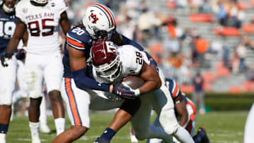 Auburn footballDec 5, 2020; Auburn, Alabama, USA; Texas A&M Aggies running back Isaiah Spiller (28) is tackled by Auburn football defensive back Jamien Sherwood (20) during the second quarter at Jordan-Hare Stadium. Mandatory Credit: John Reed-USA TODAY Sports