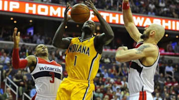 May 9, 2014; Washington, DC, USA; Indiana Pacers shooting guard Lance Stephenson (1) looses the ball as Washington Wizards shooting guard Bradley Beal (3) and Washington Wizards center Marcin Gortat (4) defend during the first half in game three of the second round of the 2014 NBA Playoffs at Verizon Center. Mandatory Credit: Brad Mills-USA TODAY Sports