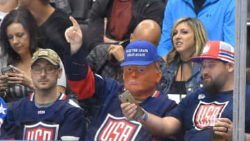 Sep 22, 2016; Toronto, Ontario, Canada; A Team USA fan wearing a Donald Trump mask gestures as he watches play against Team Czech Republic during preliminary round play in the 2016 World Cup of Hockey at Air Canada Centre. Mandatory Credit: Dan Hamilton-USA TODAY Sports