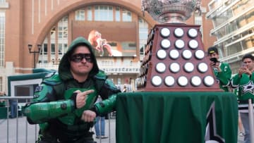 Oct 8, 2015; Dallas, TX, USA; Dallas Stars fan Matthew Day poses with the Art Ross Trophy prior to the Stars