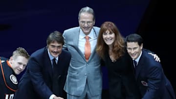 ANAHEIM, CA - NOVEMBER 19: (L-R) Corey Perry #10 of the Anaheim Ducks, former Ducks player Teemu Selanne, Ducks owners Henry and Susan Samueli and former Ducks player Paul Kariya pose for the ceremonial puck drop during the pre-game ceremony prior to the NHL game at Honda Center on November 19, 2017 in Anaheim, California. (Photo by Victor Decolongon/Getty Images)