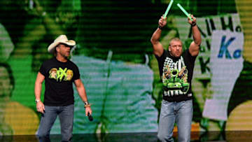 LAS VEGAS, NV - JANUARY 08: WWE personalities Shawn Michaels (L) and Triple H throw glow sticks into the crowd at a news conference announcing the WWE Network at the 2014 International CES at the Encore Theater at Wynn Las Vegas on January 8, 2014 in Las Vegas, Nevada. The network will launch on February 24, 2014 as the first-ever 24/7 streaming network, offering both scheduled programs and video on demand. The USD 9.99 per month subscription will include access to all 12 live WWE pay-per-view events each year. CES, the world's largest annual consumer technology trade show, runs through January 10 and is expected to feature 3,200 exhibitors showing off their latest products and services to about 150,000 attendees. (Photo by Ethan Miller/Getty Images)