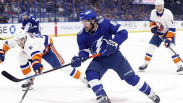 Jun 21, 2021; Tampa, Florida, USA; Tampa Bay Lightning center Tyler Johnson (9) passes the puck as New York Islanders defenseman Noah Dobson (8) defends during the first period in game five of the Stanley Cup Semifinals at Amalie Arena. Mandatory Credit: Kim Klement-USA TODAY Sports