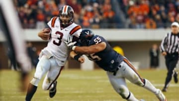 Nov 30, 2013; Charlottesville, VA, USA; Virginia Tech Hokies quarterback Logan Thomas (3) runs with the ball as Virginia Cavaliers defensive tackle David Dean (55) chases in the second quarter at Scott Stadium. Mandatory Credit: Geoff Burke-USA TODAY Sports