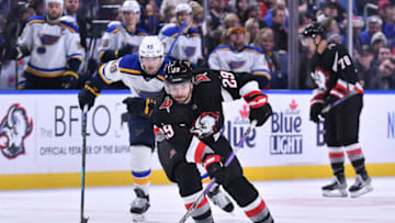 Nov 23, 2022; Buffalo, New York, USA; Buffalo Sabres center Vinnie Hinostroza (29) handles the puck in front of St. Louis Blues center Ivan Barbashev (49) in the second period at KeyBank Center. Mandatory Credit: Mark Konezny-USA TODAY Sports