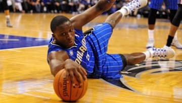 Mar 28, 2014; Orlando, FL, USA; Orlando Magic guard Victor Oladipo (5) reaches for the ball against the Charlotte Bobcats at Amway Center. Center.The Magic won 110-105 in overtime. Mandatory Credit: David Manning-USA TODAY Sports