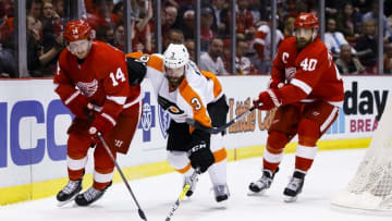 Apr 6, 2016; Detroit, MI, USA; Detroit Red Wings center Gustav Nyquist (14) Philadelphia Flyers defenseman Radko Gudas (3) and Detroit left wing Henrik Zetterberg (40) battle for the puck in the third period at Joe Louis Arena. Detroit won 3-0. Mandatory Credit: Rick Osentoski-USA TODAY Sports