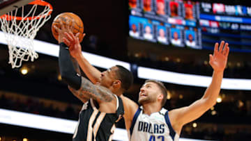 ATLANTA, GA - FEBRUARY 22: John Collins #20 of the Atlanta Hawks goes up for a shot as Maxi Kleber #42 of the Dallas Mavericks defends during the second half of an NBA game at State Farm Arena on February 22, 2020 in Atlanta, Georgia. NOTE TO USER: User expressly acknowledges and agrees that, by downloading and/or using this photograph, user is consenting to the terms and conditions of the Getty Images License Agreement. (Photo by Todd Kirkland/Getty Images)