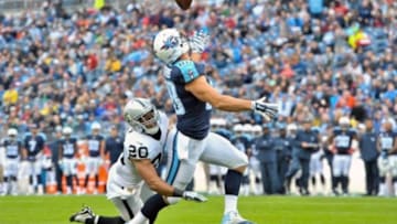 Nov 29, 2015; Nashville, TN, USA; Tennessee Titans tight end Craig Stevens (88) catches a pass for touchdown against Oakland Raiders strong safety Nate Allen (20) during the first half at Nissan Stadium. Mandatory Credit: Jim Brown-USA TODAY Sports