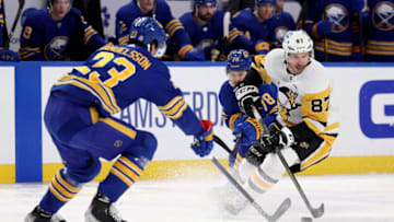 Mar 23, 2022; Buffalo, New York, USA; Pittsburgh Penguins center Sidney Crosby (87) skates with the puck as Buffalo Sabres defenseman Jacob Bryson (78) and defenseman Mattias Samuelsson (23) defend during the first period at KeyBank Center. Mandatory Credit: Timothy T. Ludwig-USA TODAY Sports