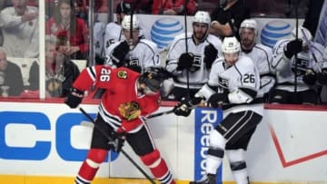 Jun 8, 2013; Chicago, IL, USA; Chicago Blackhawks center Michal Handzus (left) battles for the puck with Los Angeles Kings defenseman Slava Voynov (right) during the third period in game five of the Western Conference finals of the 2013 Stanley Cup Playoffs at the United Center. Mandatory Credit: Scott Stewart-USA TODAY Sports