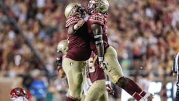 TALLAHASSEE, FL - SEPTEMBER 28: Defensive Tackle Cory Durden #16 and Lineback Dontavious Jackson #5 of the Florida State Seminoles give each other a chest bump after a play during the game against the North Carolina State Wolfpack at Doak Campbell Stadium on Bobby Bowden Field on September 28, 2019 in Tallahassee, Florida. The Seminoles defeated the Wolfpack 31 to 13. (Photo by Don Juan Moore/Getty Images)
