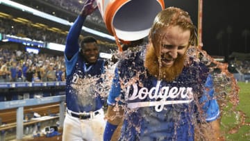 FanDuel MLB: LOS ANGELES, CA - AUGUST 25: Justin Turner #10 of the Los Angeles Dodgers is soaked with sports drink by Yasiel Puig #66 after the RBI single that scored Chris Taylor #3 in the 12th inning to defeat the San Diego Padres 5-4 at Dodger Stadium on August 25, 2018 in Los Angeles, California. All players across MLB will wear nicknames on their backs as well as colorful, non-traditional uniforms featuring alternate designs inspired by youth-league uniforms during Players Weekend. (Photo by John McCoy/Getty Images)
