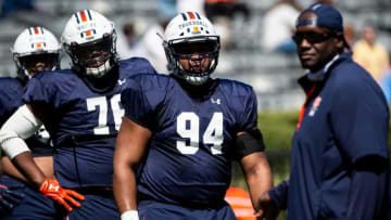 Auburn football defensive tackle Tyrone Truesdell (94) leads defensive line drills as coach Nick Eason (right) watches during an open football practice at Jordan-Hare Stadium in Auburn, Ala., on Saturday, March 20, 2021.