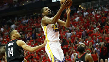 HOUSTON, TX - MAY 16: Kevin Durant #35 of the Golden State Warriors shoots against Gerald Green #14 and James Harden #13 of the Houston Rockets in the third quarter of Game Two of the Western Conference Finals of the 2018 NBA Playoffs at Toyota Center on May 16, 2018 in Houston, Texas. (Photo by Ronald Martinez/Getty Images)