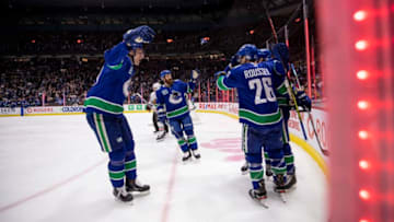 VANCOUVER, BC - FEBRUARY 20: Adam Gaudette #88 of the Vancouver Canucks celebrates his goal against goaltender Corey Crawford #50 of the Chicago Blackhawks with teammates Tyler Myers #57, Jordie Benn #4 and Antoine Roussel #26 during the second period at Rogers Arena on February 12, 2020 in Vancouver, Canada. (Photo by Ben Nelms/Getty Images)