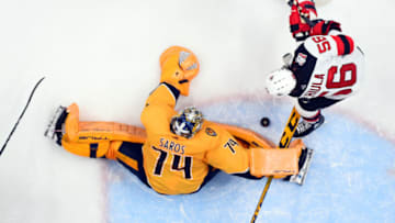 Jan 26, 2023; Nashville, Tennessee, USA; Nashville Predators goaltender Juuse Saros (74) makes a save on a shot by New Jersey Devils left wing Erik Haula (56) during the third period at Bridgestone Arena. Mandatory Credit: Christopher Hanewinckel-USA TODAY Sports