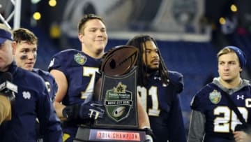 Dec 30, 2014; Nashville, TN, USA; Notre Dame Fighting Irish offensive lineman Nick Martin (72) and defensive lineman Sheldon Day (91) celebrate after winning the game against the LSU Tigers in the Music City Bowl at LP Field. Notre Dame won 31-28. Mandatory Credit: Christopher Hanewinckel-USA TODAY Sports