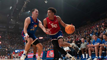 Kansas senior guard Kevin McCullar Jr. (15) drives the ball against senior guard Nicolas Timberlake (25) during a scrimmage at Friday's Late Night in the Phog inside Allen Fieldhouse.