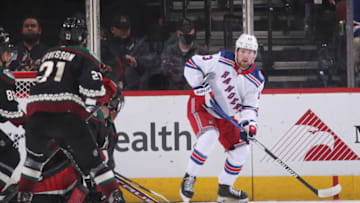 GLENDALE, ARIZONA - DECEMBER 15: Alexis Lafrenière #13 of the New York Rangers skates with the puck during the NHL game at Gila River Arena on December 15, 2021 in Glendale, Arizona. The Rangers defeated the Coyotes 3-2. (Photo by Christian Petersen/Getty Images)