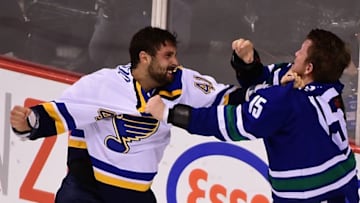 Oct 16, 2015; Vancouver, British Columbia, CAN; St. Louis Blues defenseman Robert Bortuzzo (41) fights against Vancouver Canucks forward Derek Dorsett (15) during the second period at Rogers Arena. Mandatory Credit: Anne-Marie Sorvin-USA TODAY Sports