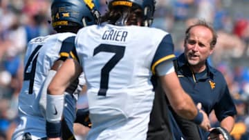 LAWRENCE, KS - SEPTEMBER 23: Dana Holgorsen head coach of the West Virginia Mountaineers congratulates Kennedy McKoy