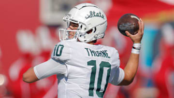BLOOMINGTON, IN - OCTOBER 16: Payton Thorne #10 of the Michigan State Spartans warms up before the game against the Indiana Hoosiers at Indiana University on October 16, 2021 in Bloomington, Indiana. (Photo by Michael Hickey/Getty Images)