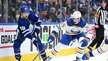 Apr 12, 2022; Toronto, Ontario, CAN; Toronto Maple Leafs forward William Nylander (88) passes the puck past Buffalo Sabres defenseman Owen Power (25) in the first period at Scotiabank Arena. Mandatory Credit: Dan Hamilton-USA TODAY Sports