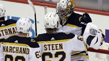 Mar 16, 2021; Pittsburgh, Pennsylvania, USA; Boston Bruins right wing Oskar Steen (62) and goaltender Daniel Vladar (80) celebrate after defeating the Pittsburgh Penguins at PPG Paints Arena. Boston won 2-1. Mandatory Credit: Charles LeClaire-USA TODAY Sports
