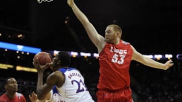 Dec 14, 2013; Kansas City, MO, USA; New Mexico Lobos center Alex Kirk (53) defends against Kansas Jayhawks center Joel Embiid (21) in the second half at Sprint Center. Kansas won 80-63. Mandatory Credit: John Rieger-USA TODAY Sports