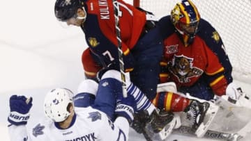 Apr 10, 2014; Sunrise, FL, USA; Florida Panthers defenseman Dmitry Kulikov (7) checks Toronto Maple Leafs left wing James van Riemsdyk (21) in front of goalie Roberto Luongo (1) in the third period at BB&T Center. The Panthers won 4-2. Mandatory Credit: Robert Mayer-USA TODAY Sports