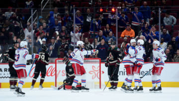 Dec 15, 2021; Glendale, Arizona, USA; New York Rangers right wing Kaapo Kakko (24) celebrates a goal against Arizona Coyotes goalie Scott Wedgewood (31) during the third period at Gila River Arena. Mandatory Credit: Joe Camporeale-USA TODAY Sports