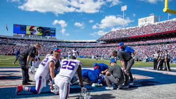 ORCHARD PARK, NY - SEPTEMBER 16: Buffalo Bills players and medical staff gather around Taiwan Jones #26 of the Buffalo Bills after he was hit without his helmet during the third quarter against the Los Angeles Chargers at New Era Field on September 16, 2018 in Orchard Park, New York. (Photo by Brett Carlsen/Getty Images)