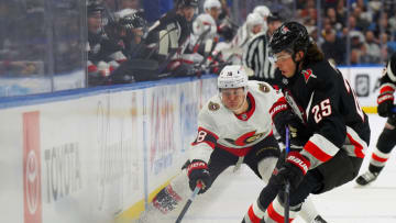 BUFFALO, NY - APRIL 13: Owen Power #25 of the Buffalo Sabres and Tim Stützle #18 of the Ottawa Senators go after a loose puck in the corner during the first period at KeyBank Center on April 13, 2023 in Buffalo, New York. (Photo by Kevin Hoffman/Getty Images)