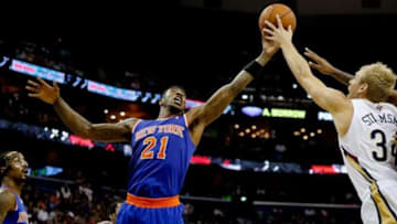 Feb 19, 2014; New Orleans, LA, USA; New York Knicks shooting guard Iman Shumpert (21) and New Orleans Pelicans center Greg Stiemsma (34) battle for a rebound during the first half of a game at the Smoothie King Center. Mandatory Credit: Derick E. Hingle-USA TODAY Sports