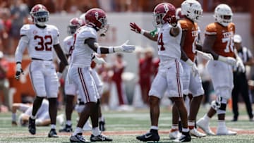 AUSTIN, TEXAS - SEPTEMBER 10: Jordan Battle #9 of the Alabama Crimson Tide congratulates Brian Branch #14 after a tackle in the first half against the Texas Longhorns at Darrell K Royal-Texas Memorial Stadium on September 10, 2022 in Austin, Texas. (Photo by Tim Warner/Getty Images)